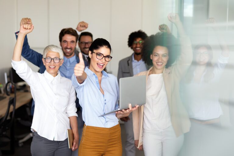 Group of successful multiethnic business people celebrating a good job in the office